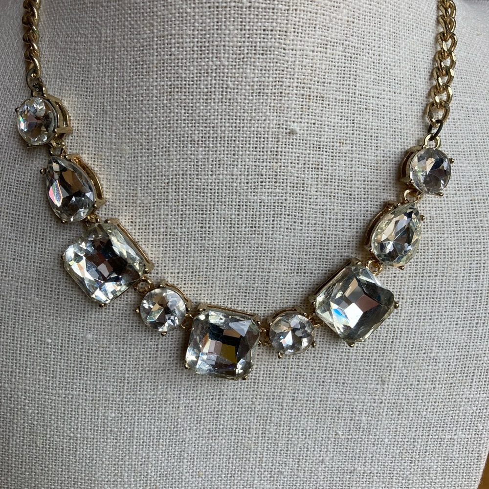 Crystal stone necklace with gold chain.